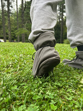 Load image into Gallery viewer, Person wearing a gray pants with high cuffs in a grassy area
