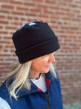 Load image into Gallery viewer, Person wearing a black Arctic Circle cap in front of a brick wall
