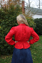 Load image into Gallery viewer, Back of the red shirt on a woman in a lawn. Her hands are on her hips
