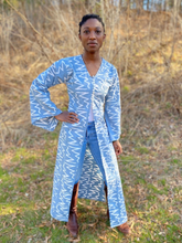 Load image into Gallery viewer, Black woman wearing a long blue/grey batiked entari with brown boots.  She is standing outside.

