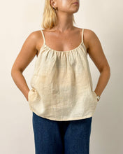 Load image into Gallery viewer, Woman wearing a beige tank top and blue pants against a plain background
