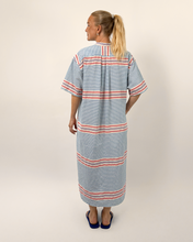 Load image into Gallery viewer, Woman wearing a striped dress with a plain background
