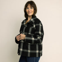 Load image into Gallery viewer, Woman wearing a black and gray checkered coat against a plain background
