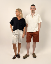 Load image into Gallery viewer, Two people standing side by side against a plain background
