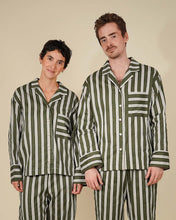 Load image into Gallery viewer, A man and a woman modeling matching green and white vertically striped pajama sets against a solid beige background.
